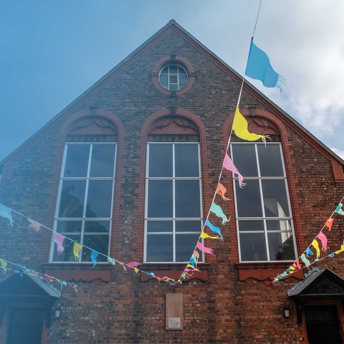 Village hall exterior decorated with colourful bunting
